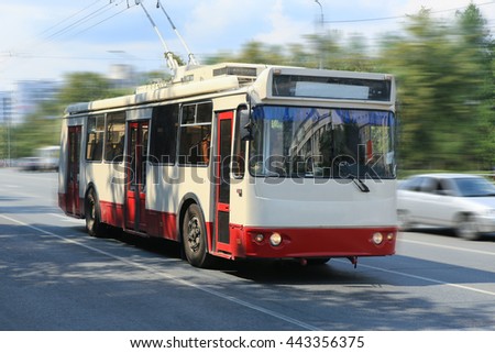 trolleybus going on the city street Royalty-Free Stock Photo #443356375