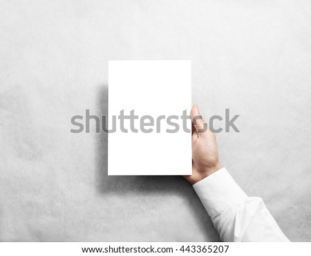 Hand holding blank white brochure booklet in the hand. Leaflet presentation. Pamphlet hold hand. Man show book offset paper. Sheet template. Booklet design. Paper sheet display read first person Royalty-Free Stock Photo #443365207