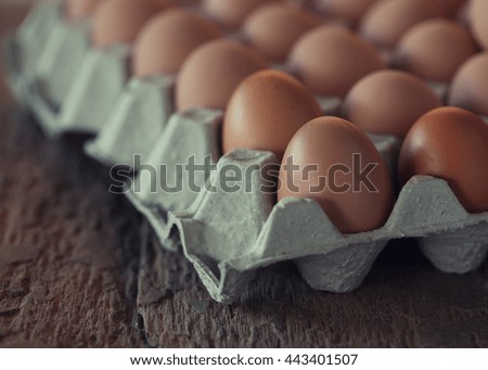 Chicken Egg in paper tray on wooden background - vintage effect style pictures.