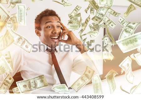 Young happy african american businessman with abstract dollar bill rain
