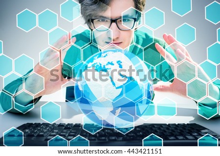 Young man holding abstract terrestrial globe with digital honeycomb pattern. Elements of this image furnished by NASA