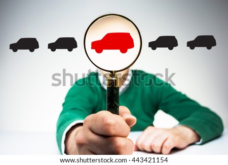 Magnifier with red car icon instead of man's head on light background with black car icons. Concept of choice Royalty-Free Stock Photo #443421154