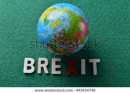 word BREXIT on green background with Globe. Low light photography