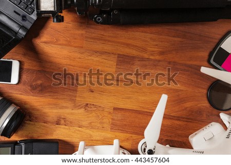  The tools of a professional photographer and video on wooden background 