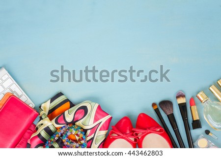 styled feminine desktop - woman fashion items on blue wooden background border with copy space