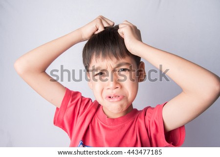 Little boy itchy his head stress face headache