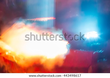 Abstract background pattern with space bright colorful orange laser rays, smoke and flash