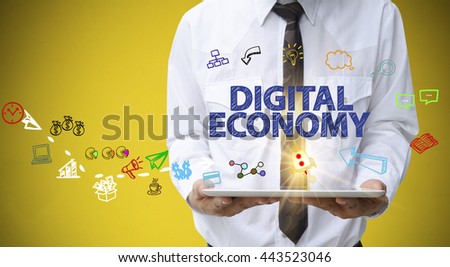 businessman holding a tablet computer with DIGITAL ECONOMY text ,business analysis and strategy as concept