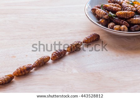 Wood worm insect crispy walking into the dish on wooden background, Abstract, Conception images