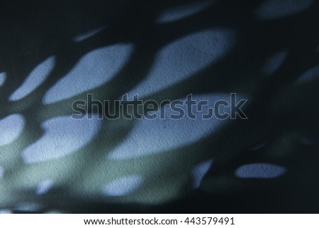Abstract beautiful mysterious dark and light background with blue blurry rounded cell like shadows resembling butterfly wing on rough watercolor paper texture