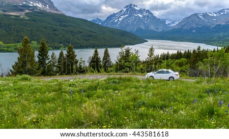 Stormy Mountain Lake Valley - A panoramic spring view of a stormy  evening at Lower Two Medicine Lake, with Rising Wolf Mountain in the background, Glacier National Park, Montana, USA.