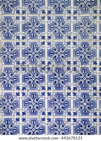 A piece of an old blue ceramic tile in Portugal on the wall of a house