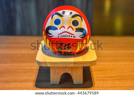 Daruma doll japanese symbolise on wood table Royalty-Free Stock Photo #443679589