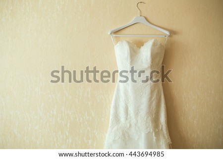 wedding dress on hanger on a wall. Beautiful gown Royalty-Free Stock Photo #443694985