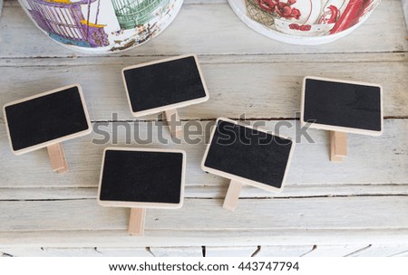 Many of vintage blackboard with wooden frame on white vintage table