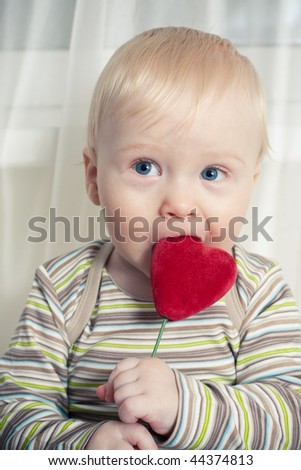 funny boy with heart in mouth