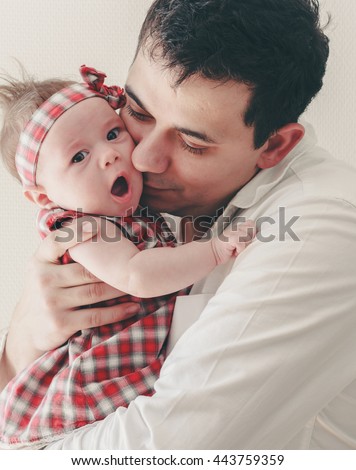 Happy family young father and child baby girl,father  hugging and kissing his baby daughter
