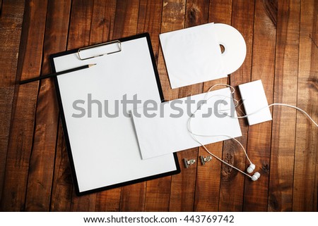 Photo of blank stationery set. Blank corporate identity template on vintage wooden table background. Responsive design template. Mock-up for your design.