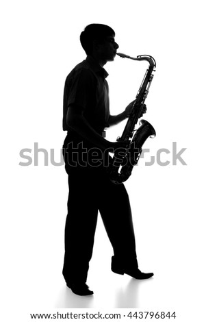 portrait of the silhouette of a young man in a suit playing a wind instrument