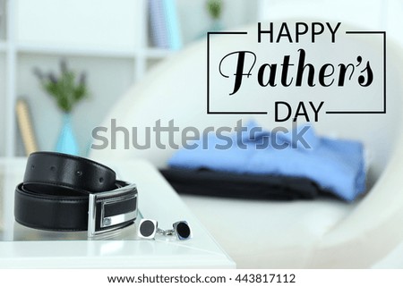 Happy father's day concept. Male belt and cufflinks on coffee table