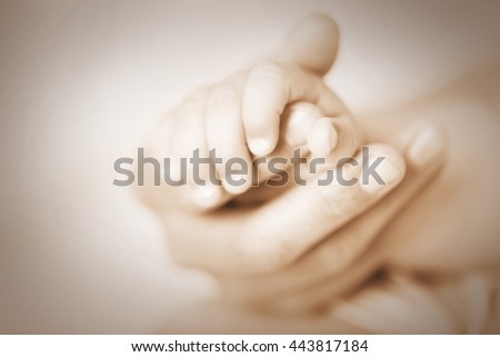 Adult and baby hands, closeup