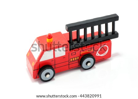 Close up wooden vintage toy fire fighter truck, isolated in white background. Very fast to rescue children safe from fire.