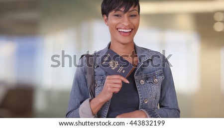 Woman with US Passport in airport terminal while waiting for flight Royalty-Free Stock Photo #443832199