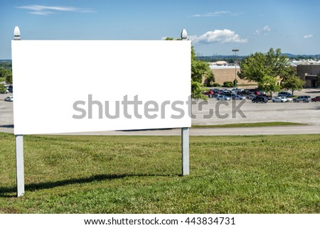 Blank Real Estate Sign In Front Of Retail Complex