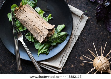 Diet meat wrap with greens in a black plate