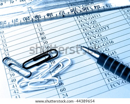 Ruler and pen against the table, in blue.