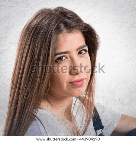 Pretty girl posing in studio over grey background