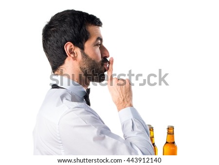 Waiter with beer bottles on the tray making silence gesture