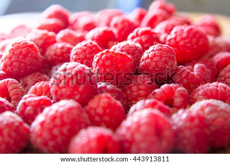 Ripe sweet juicy raspberries on wooden table. Close up, top view