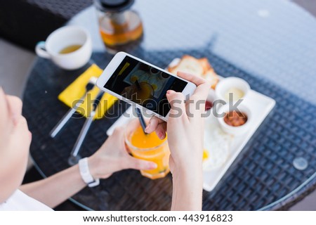 Woman hands taking food photo by mobile phone. Food photography. Delicious breakfast.