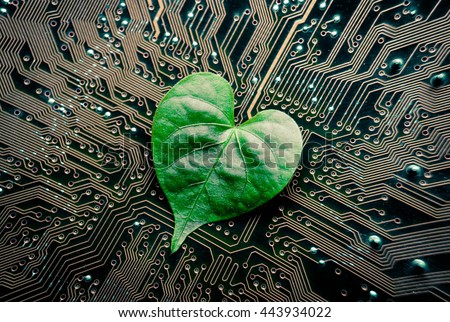 A green leaf with a heart shape on a computer circuit board / green it / green computing / csr / it ethics
