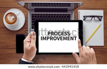 PROCESS IMPROVEMENT, on the tablet pc screen held by businessman hands - online, top view