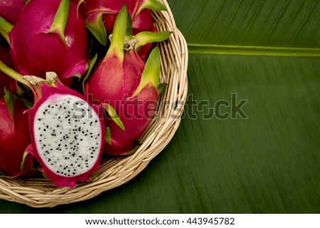 dragon fruit basket on green background.