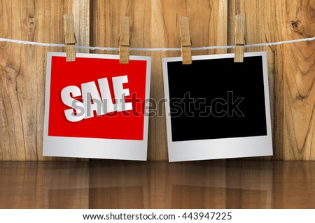 Sale paper label in photo frame paper hanging on wooden background, discount banner.