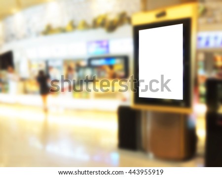 Blurred image of advertising board with shopping mall background