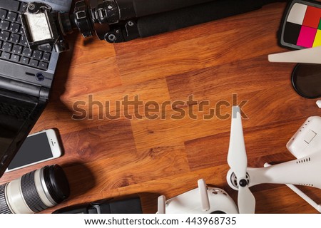  The tools of a professional photographer and video on wooden background 
