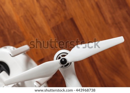 White Drone on wooden background 