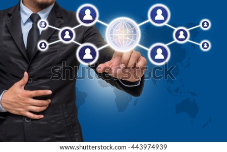 Businessman pointing or touching the Social media symbol on blue color background with world map,Elements of this image furnished by NASA, Business network concept