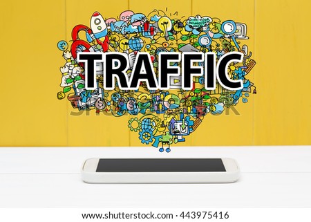 Traffic concept with smartphone on yellow wooden background