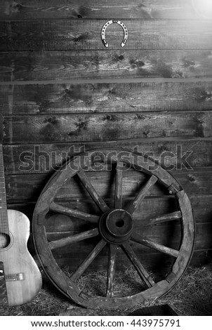 old shed in the morning at sunrise. Old wagon wheel and guitar