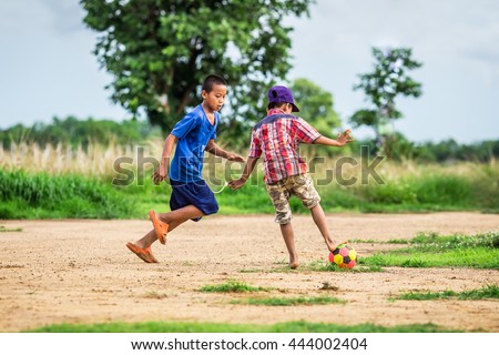 The kids are playing football in the sunshine day. A high dynamic range picture style.