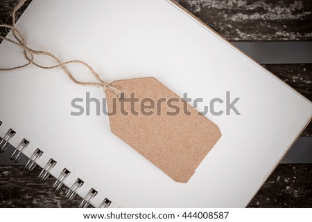 tag paper with nature lope on empty blank white notebook paper for your text.