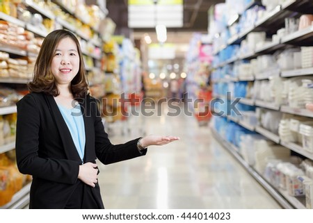 Smiling business woman presenting. Welcome! on background. Can use for product display