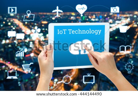 woman hand using smart phone in concept internet of things with blurred night modern city background
