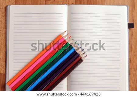 Blank notebook with color pencil. Education concept