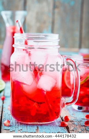cold homemade lemonade with pomegranate, mint and lime in mason jar